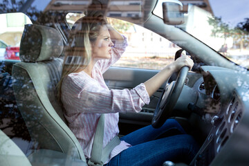 Young blonde woman losing her nerves while driving
