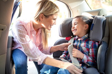 Responsible parent securing her child with a seatbelt