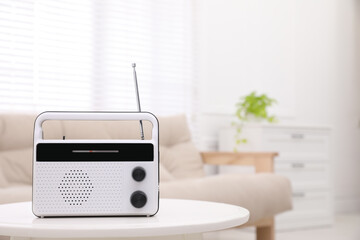 Stylish white radio on table indoors. Space for text