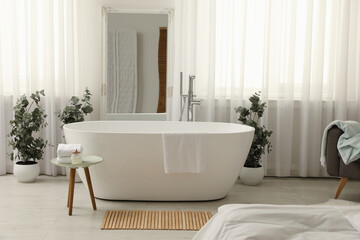 White tub and decor in light room. Interior design