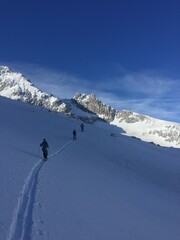 Fototapeta na wymiar three men are on a ski tour in the German Alps