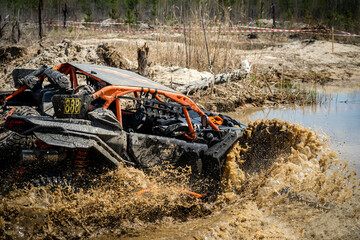 ATV and UTV offroad vehicle in water road with mud splash.