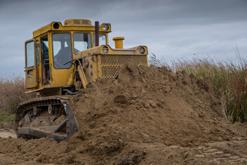 Bul'dozer removes dam in the delta Danube river. Close up