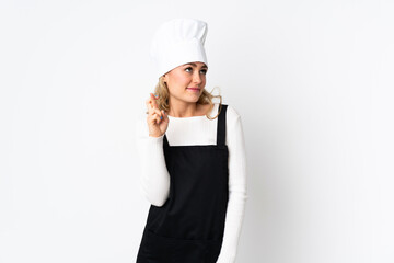 Young Brazilian chef woman isolated on white background with fingers crossing and wishing the best
