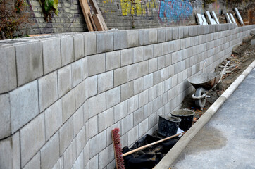 ugly holding a road notch of a bridge forecourt tunnel. retaining wall with concrete grouting is...