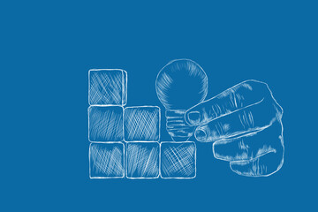 holding a light bulb by the stairs made of wooden cubes