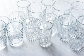 Empty drink glasses on white kitchen table.