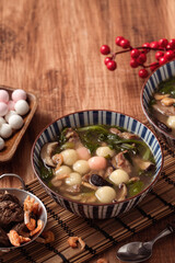 Red and white tangyuan with savory soup.