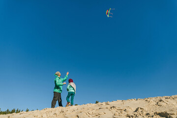 Father with his 5 years old daughter prepairing kite to fly