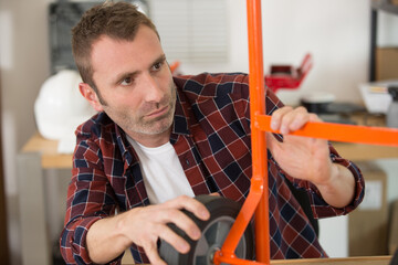 man with sack truck on work bench