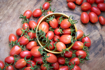 fresh and ripe cherry tomato with green leaf (Solanum lycopersicum L. var. cerasiforme., Solanaceae)