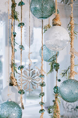 Christmas decorations, silver snowflakes and balloons on tree