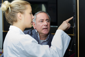 apprentice asking supervisor for instructions to operate machine