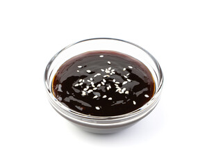 Teriyaki sauce with sesame seeds isolated on a white background.