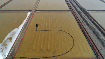 Workers drive machinery to produce labor in salt fields, North China