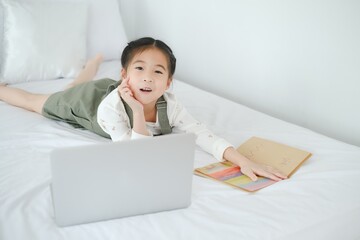 Asia little cut girl learning online at home
