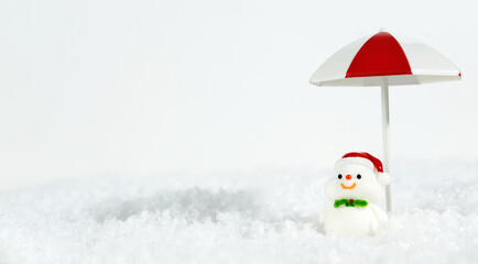 Layout of winter beach christmas holiday holiday. Happy snowman on a snowy white background under a...