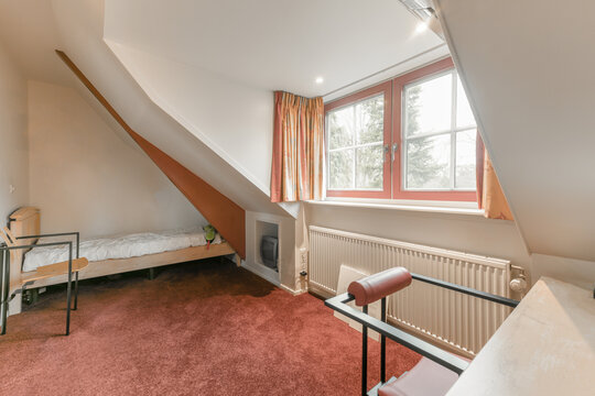 Light Attic Interior With Chair And TV Near Bed