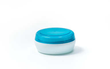 Empty White Plastic opaque cream jar with blue translucent lid. Isolated on white background. Cosmetic product for skin care, Clipping path included
