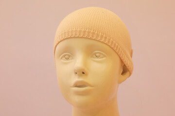 A doll model in a wool hat
