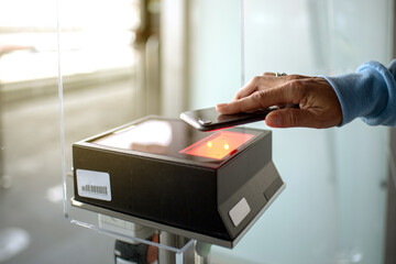 Unrecognizable person scanning boarding pass