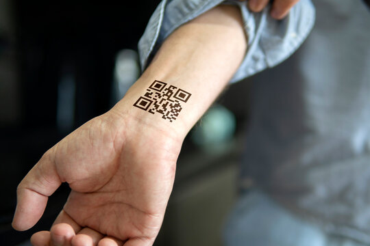 Man Shows His Hand With A Qr Code, A Confirmation Of The Vaccination Against The Covid 19 Coronavirus. Temporary Tattoo On Wrist, Carpus