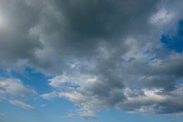 Obraz premium Russia. The South of Eastern Siberia. Gloomy sunset clouds in the evening summer sky over the mountain ranges of Eastern Sayan.