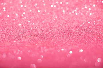 Defocused pink glittering background with shinig bokeh.