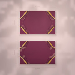 Burgundy business card with antique gold pattern for your contacts.