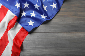American flag on wooden table, top view. Space for text