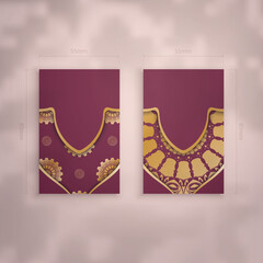 Burgundy business card with Greek gold pattern for your brand.