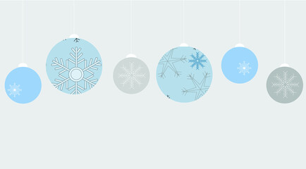 Beautiful Christmas ornaments hanging from top of frame on pale grey background with copy space. Winter, holiday theme, seasonal, greeting card.