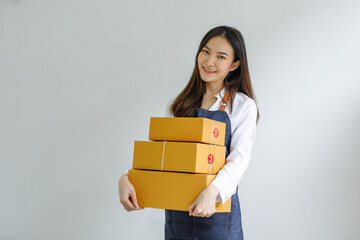 Portrait of Starting small businesses SME owners female entrepreneurs working on receipt box and check online orders to prepare to pack the boxes, sell to customers, sme business ideas online.