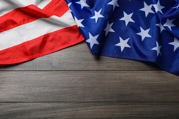 Fototapeta na wymiar American flag on wooden table, top view. Space for text