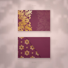 Burgundy business card with Indian gold ornaments for your personality.