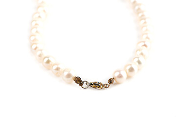 Selective focus on the lock of a pearl bead necklace.