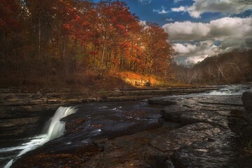 This image showcases a rushing water landscape at Cataract Falls in Indiana on a beautiful autumn day.