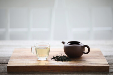 Glass tea cup and clay tea pot
