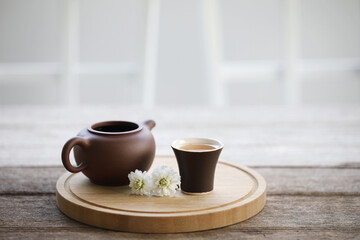 Tea cup and clay teapot with flower