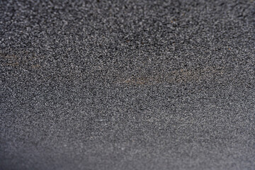 Black rubber coating made of recycled rubber chips on the sports field. Selective focus