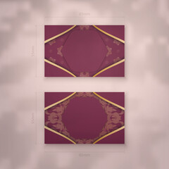 Business card in burgundy color with abstract gold pattern for your business.