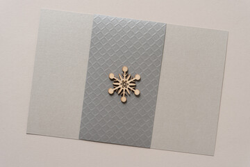 isolated wooden snowflake or star on paper