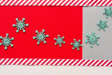 red and white ribbon with blue snowflakes on red paper