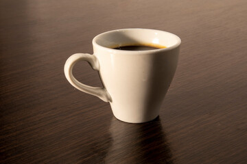 White cup of espresso on the table