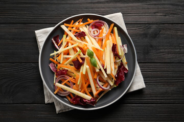 Fresh turnip salad on dark wooden table, top view