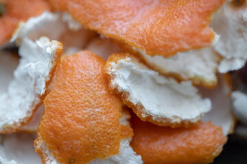 Peeled tangerine peel on a wooden cutting board, orange peel, close-up.