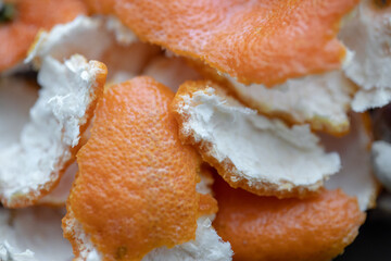 Peeled tangerine peel on a wooden cutting board, orange peel, close-up.