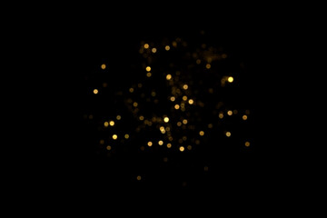 Golden blurred bokeh lights on black background. Glitter sparkle stars for celebrate. Overlay for...