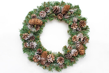 Fototapeta na wymiar Christmas wreath with fir branches and cones