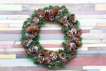 Christmas wreath on wooden multicolored background